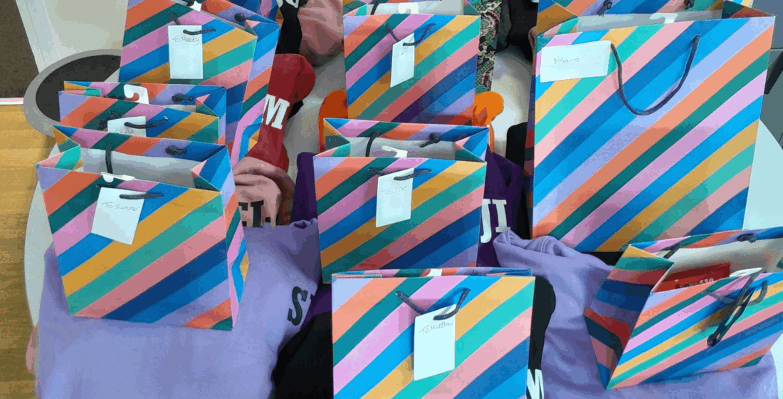 Year 11 and Year 12 learners celebrate the end of their GCSE journey at TLC School, receiving leavers' hoodies and recognising their achievements alongside families and staff.