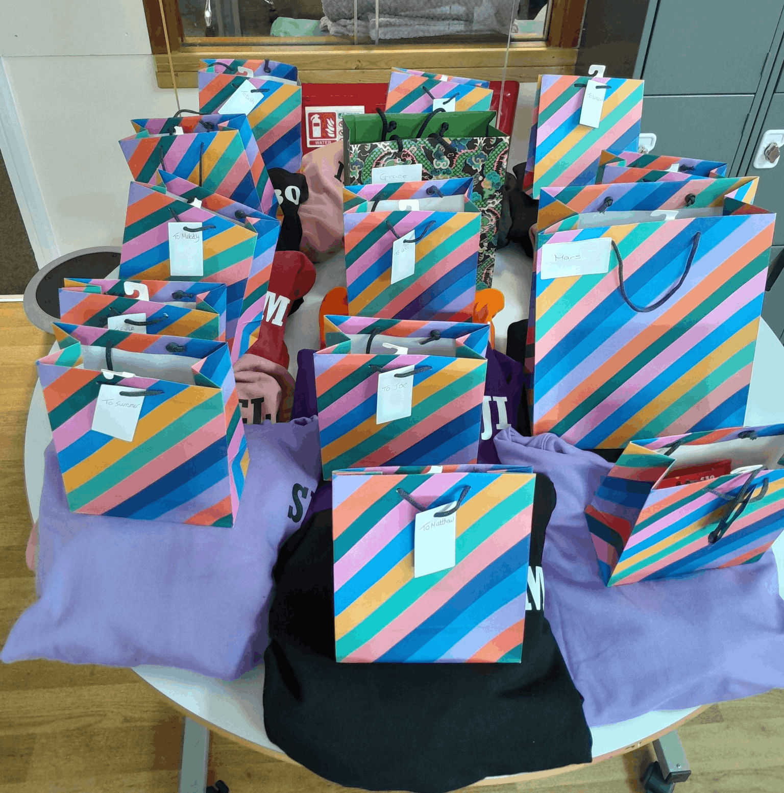 Year 11 and Year 12 learners celebrate the end of their GCSE journey at TLC School, receiving leavers' hoodies and recognising their achievements alongside families and staff.